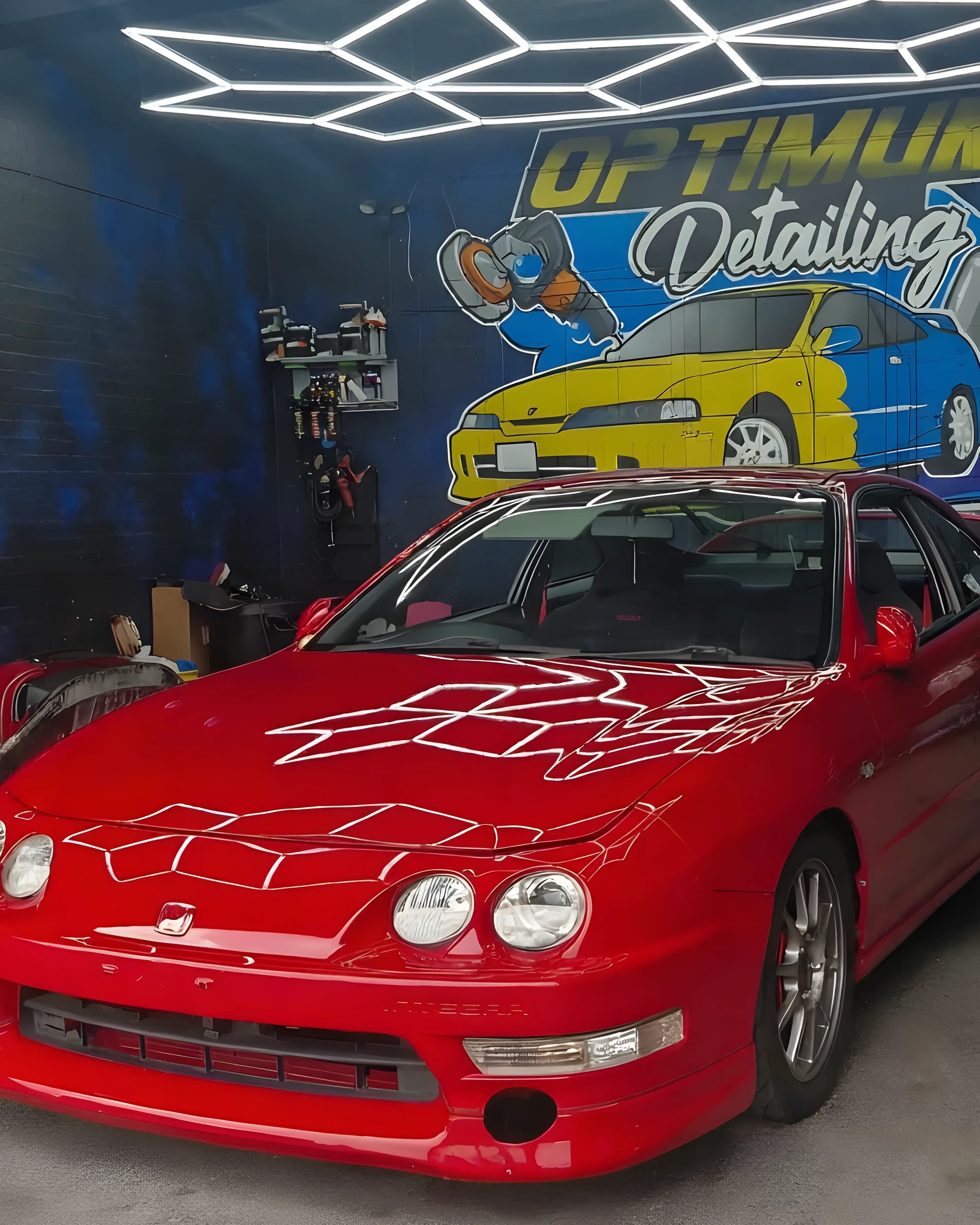 A red coupe in the Optimum Detailing studio