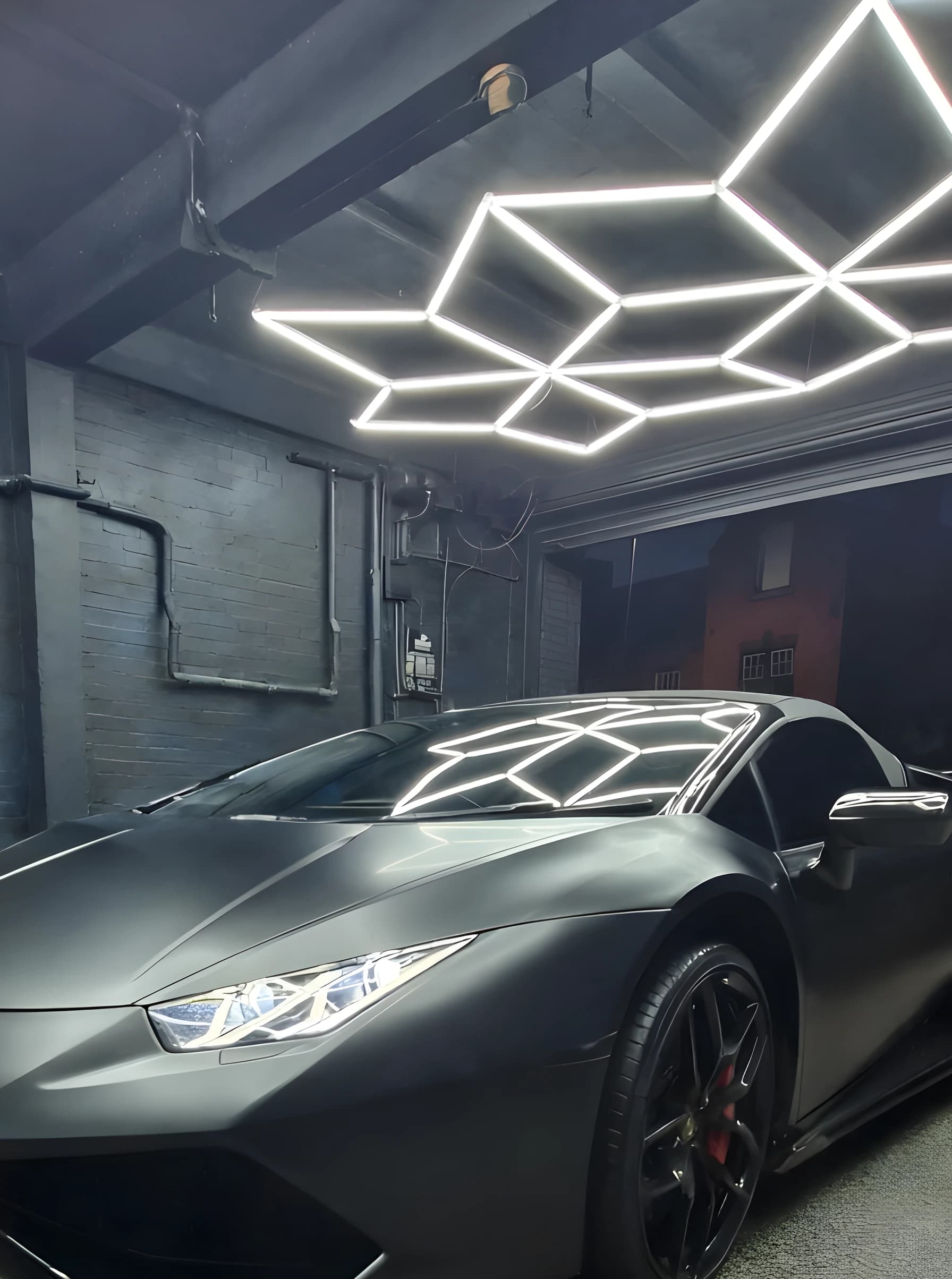 The detailing bay at Optimum Detailing under its hexagonal lighting